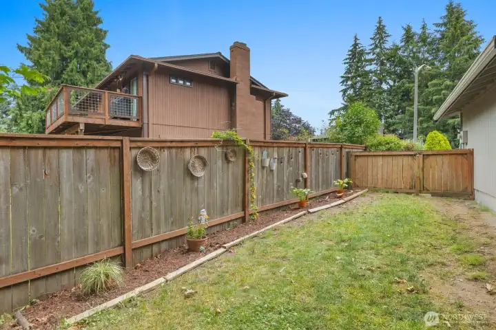 View of the side fence and gate accessible from the right of the driveway View of the side fence and gate accessible from the right of the driveway