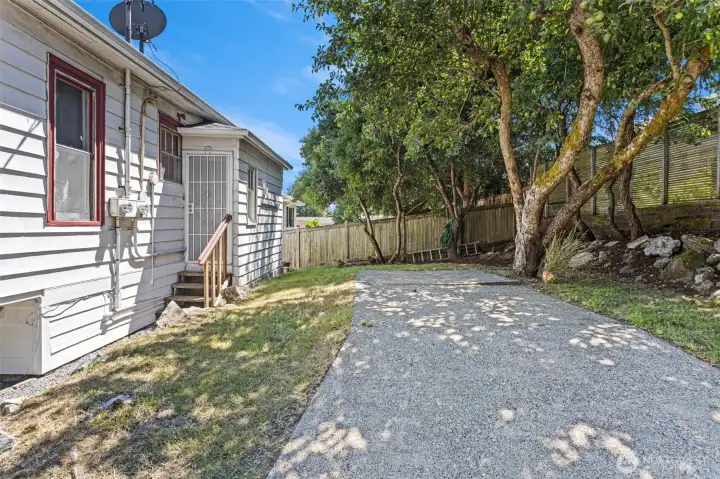 Outside unit A's kitchen door is the backyard with a long garden bed, Italian plum and apple trees. The retired driveway is a nice place for a picnic table and BBQ. Outside unit A's kitchen door is the backyard with a long garden bed, Italian plum and apple trees. The retired driveway is a nice place for a picnic table and BBQ.