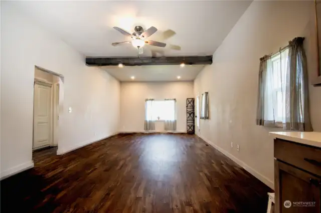 Large open living room off the kitchen with extra tall ceilings