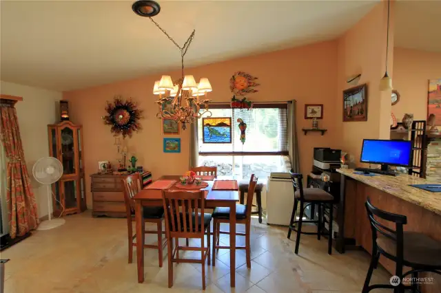 The dining room features a large window that bathes the space in natural light, creating a warm and inviting atmosphere.