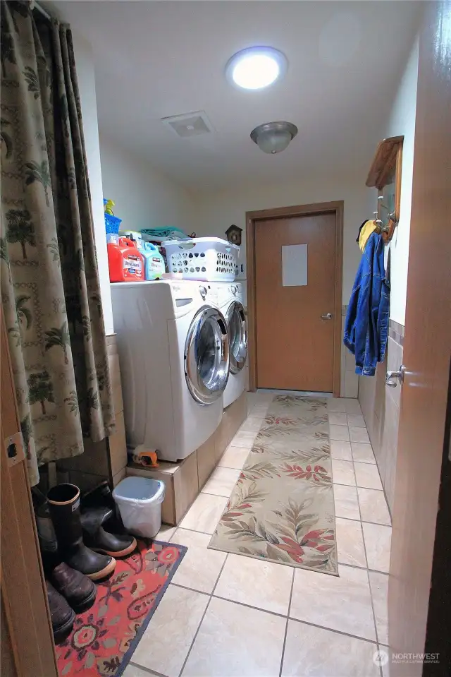 This well-equipped laundry/utility room offers convenience and efficiency for all your laundry needs.