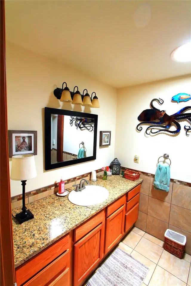 This beautifully designed guest bath features modern fixtures and elegant finishes.