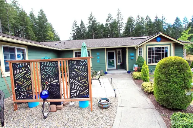 Welcoming front entry and patio with mature landscape sets the tone for this lovely home.