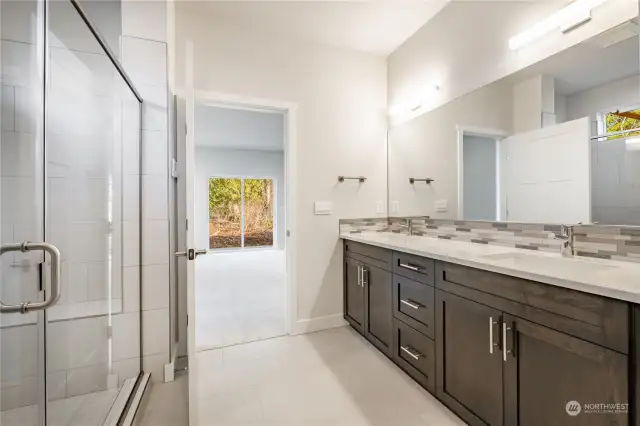 Primary bath with double sinks and huge walk-in shower with bench