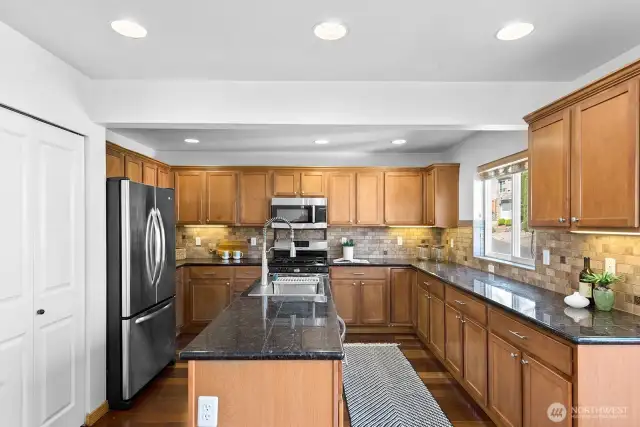 Check out this beautiful kitchen! That door on the left is a large pantry.