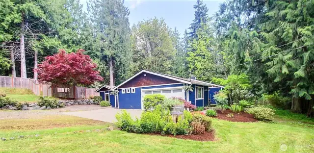 From entry drive directly to side of home and garage. Surrounded by beautiful trees and brush but the lot itself is mostly clear and allows plenty of sun in.