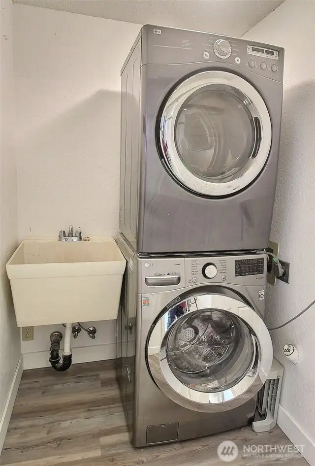 Stacked full sized washer and dryer with accompanying sink