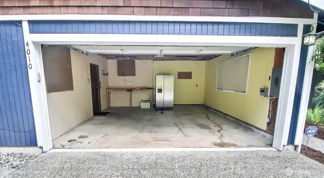 Full sized 2-car garage drywalled and includes a panel for generator hookup