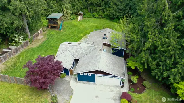 Aerial view of the fenced yard and home