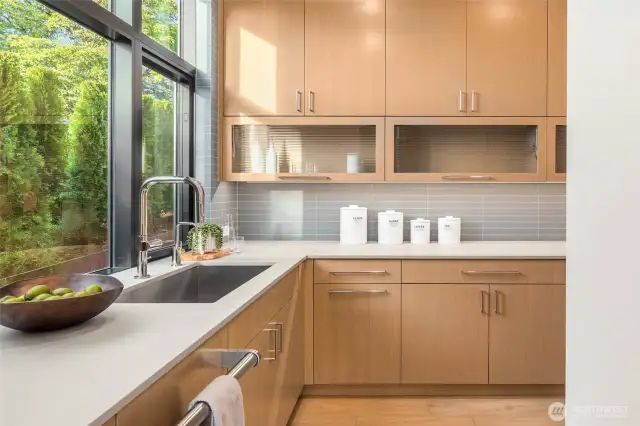 Scullery Kitchen with Custom Cabinets, Slab Counter, Full-height Tile Backsplash, Stainless Steel Sink, Wolf Single  Oven, Wolf Microwave and Cove Dishwasher