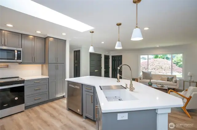 Plenty of elegant cabinets with a stunning backsplash, and under counter lights transform the space.