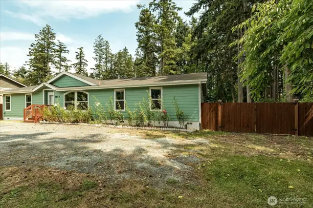 Front yard with double-gated fence.