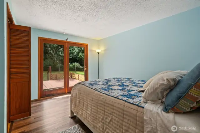 Primary bedroom with French doors to back deck and fenced back yard