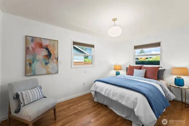 With front-facing windows and refinished oak flooring extending in, bedroom one offers warmth and light.