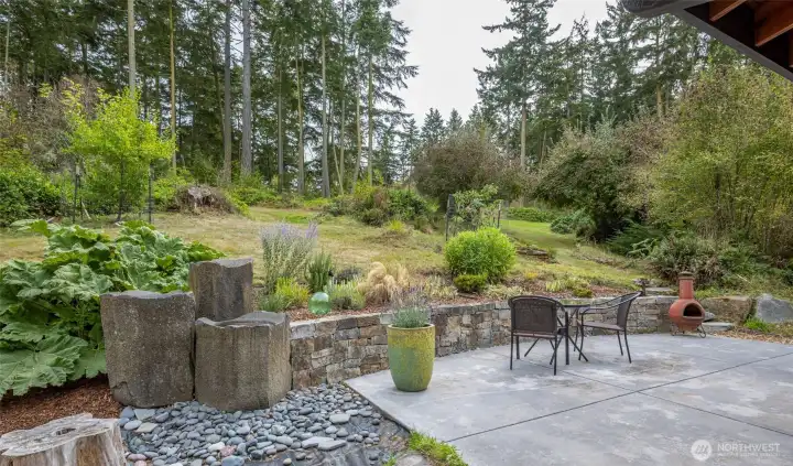 Now we'll head up through the wild rhododendrons and salal to the guest cottage and shop.