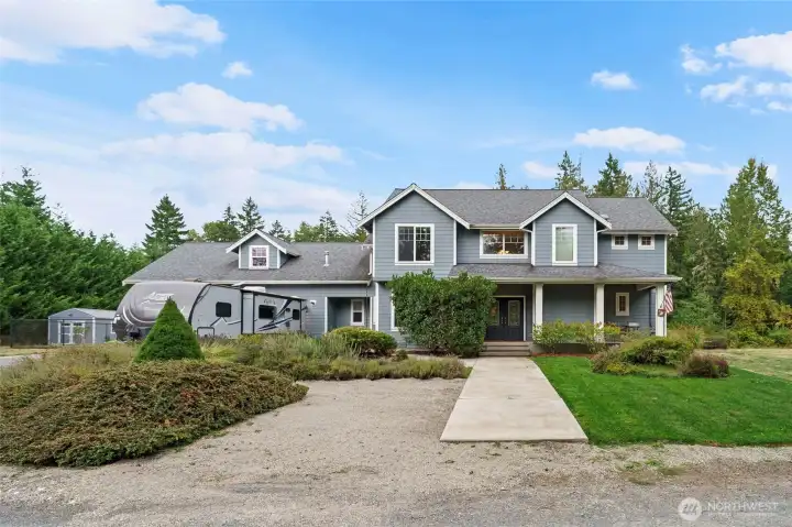 Expansive front porch is perfect for morning coffee and taking in the natural landscaping that surrounds the home.