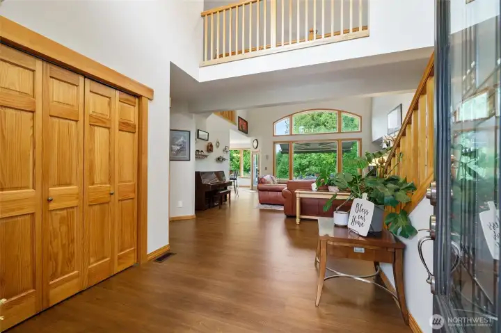 Soaring entry with beautiful flooring flowing throughout main living areas.