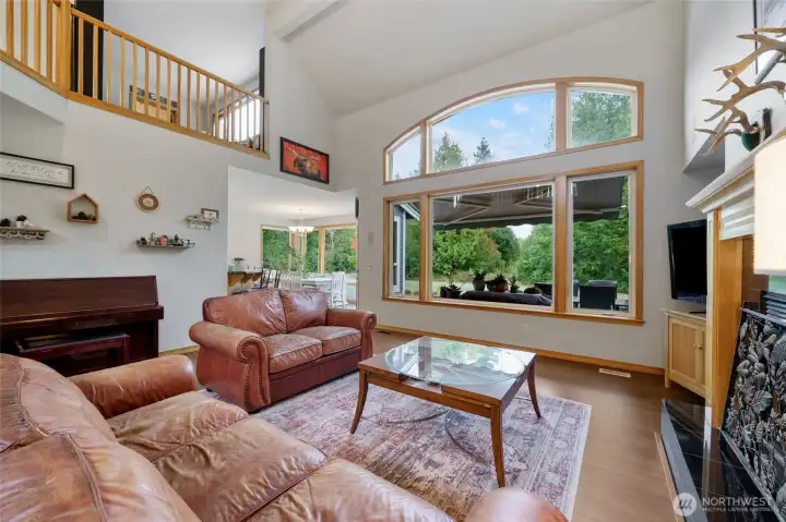 Sunlit living room with vaulted ceilings and designer windows.