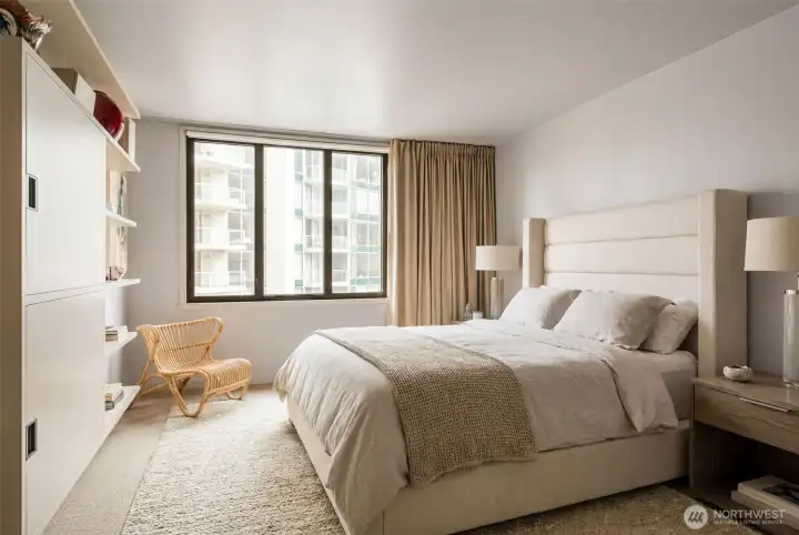 Primary bedroom with double windows for noise control also has an AV cabinet/book shelf wired for TV and speakers for bedroom and bath.