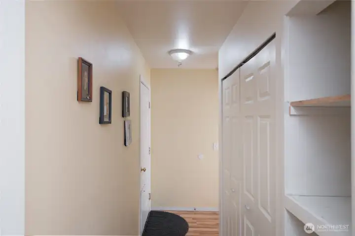 Hallway with washer and dryer hookups to right.