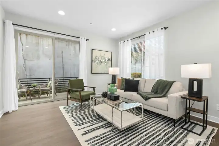 Main living at top of stairs with oversized sliding glass door to the first private balcony.