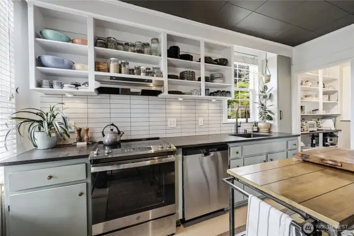 Subway tiles, quartz counter tops, stainless steel appliances.