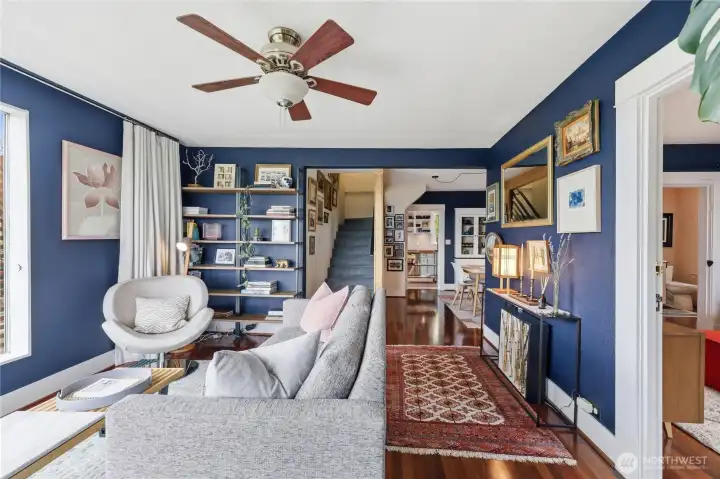A view of the other end of the living room. Stairs leading up to the 2nd primary bedroom and bathroom.