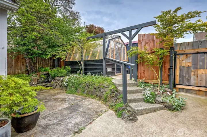 Beyond the garage is the greenhouse and fountain feature!