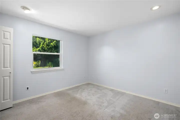 A spacious bedroom with comfortable-on-the-feet carpeting, closet and sunny backyard private window A spacious bedroom with comfortable-on-the-feet carpeting, closet and sunny backyard private window