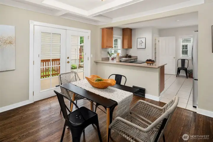 Dining Room with box beam ceilings and French Doors which lead to the back yard.