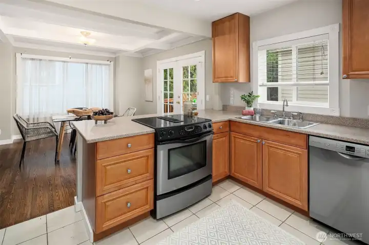 Stainless steel appliances, slab stone countertops and ceramic tile flooring.
