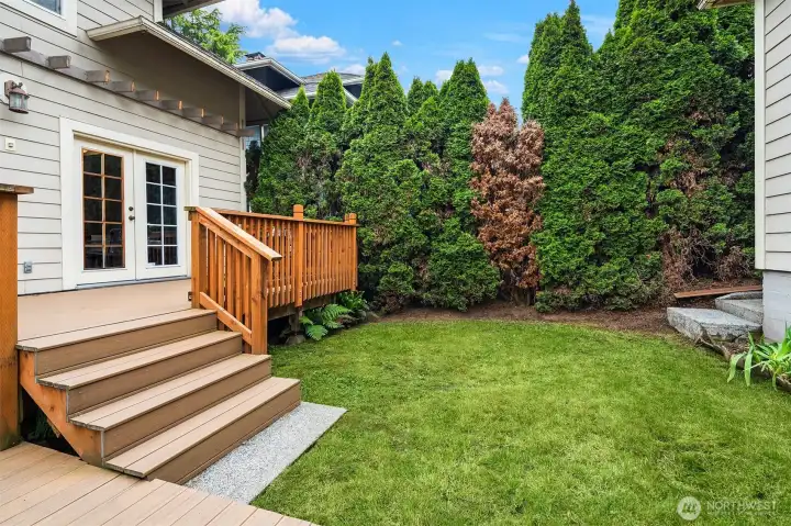 Lush backyard offers privacy.