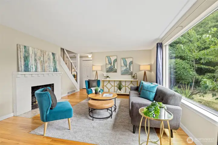 Once inside you are greeted by a large Family room with enormous window and wood burning fireplace. Once inside you are greeted by a large Family room with enormous window and wood burning fireplace.