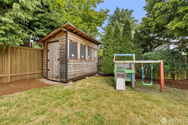 Big fully fenced back yard features large storage shed Big fully fenced back yard features large storage shed