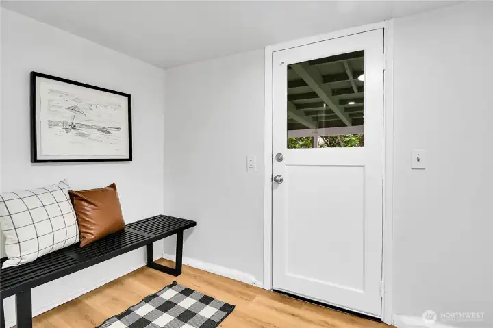 Welcoming lower-level entry with durable new laminate flooring and plenty of space for a bench, cubbies, or everyday storage. Welcoming lower-level entry with durable new laminate flooring and plenty of space for a bench, cubbies, or everyday storage.