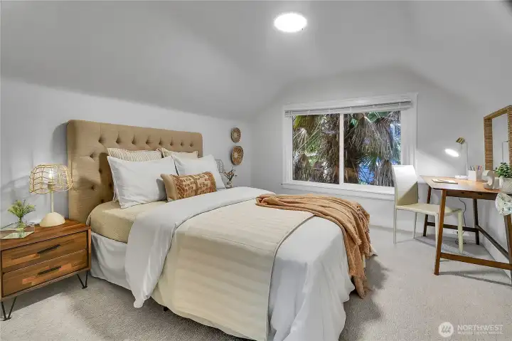 Spacious upper-level bedroom with new carpet and plenty of room for a desk, reading nook, or vanity. Spacious upper-level bedroom with new carpet and plenty of room for a desk, reading nook, or vanity.