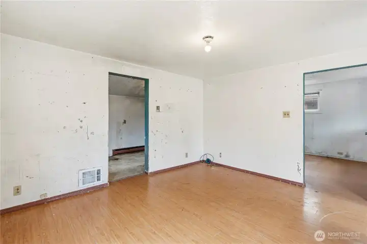 Another view of the living room showing the adjacent front bedroom to the right of the entrance and kitchen to the left.