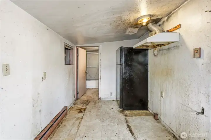 Off of the kitchen is the full bathroom.