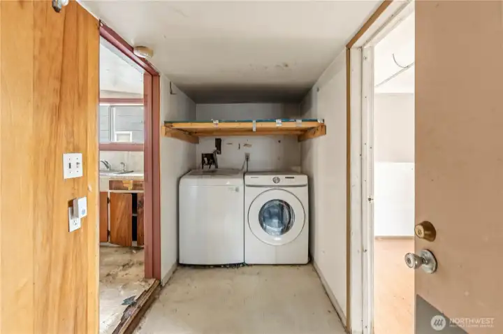 Past the kitchen is the utility room with a full-size Washer/Dryer set that stays.