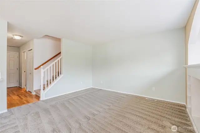 Living room. Foyer to the left to the front door, garage entrance and 1/2 bath as well as the staircase to the upper level.
