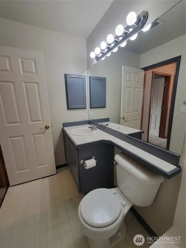 Full bathroom serving the second and third bedrooms on the upper level.