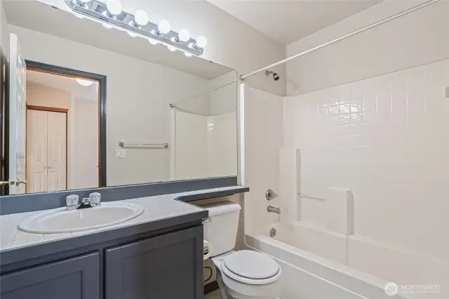 Full bathroom serving the second and third bedrooms on the upper level.