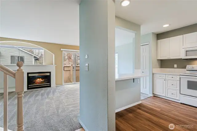 Standing in the foyer you have the front door and door to the attached garage behind as well as the 1/2 bath. Looking into the living room, to the right the kitchen, left you can start to see the railing for the stairs to the upper level. Slider visible to your private, fully fenced back yard.