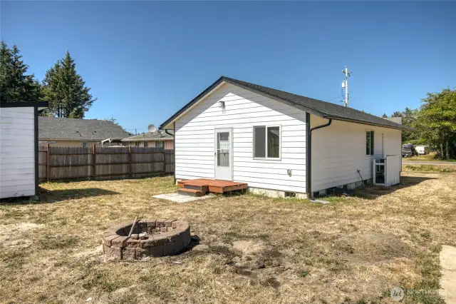Fire pit, shed, and small patio in the back yard