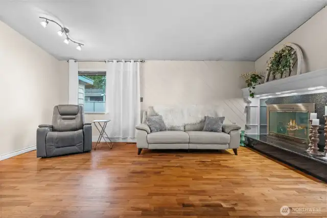 Step in the front door to natural hardwoods throughout the home and high vaulted ceilings.