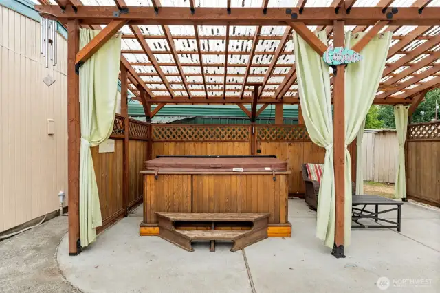 Enjoy soaking in the hot tub year round under the covered cabana!