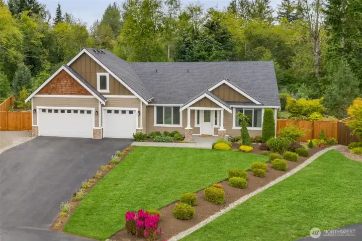 Stunning curb appeal showcasing timeless design, peaceful setting and welcoming presence in Monroe's private Kaiana Meadows community.