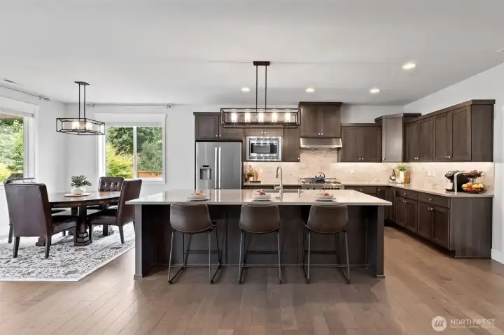 Open to living area, the gourmet kitchen is clean, modern and thoughtfully designed with convenient eating area; ideal for entertaining and enjoying everyday life.