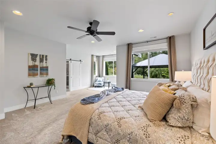 The expansive primary suite is a true sanctuary featuring blackout blinds for complete privacy and comfort along with elegantly designed bath and gorgeous custom California Closets walk-in.