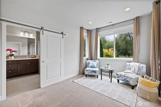 Sitting nook for reading or additional in bedroom office.